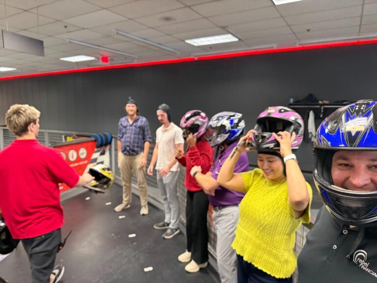 Phil Ratcliff in a racing helmet with the rebel Financial team suiting up for go-karts