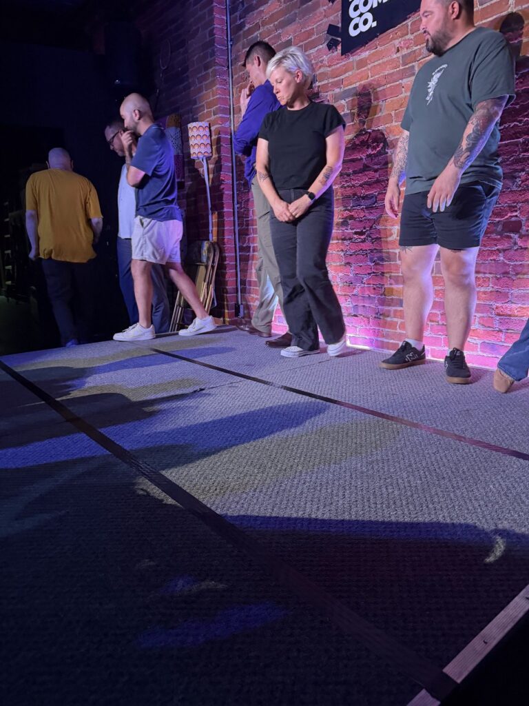 Improv class lined up on stage at The Hashtag Comedy Co.