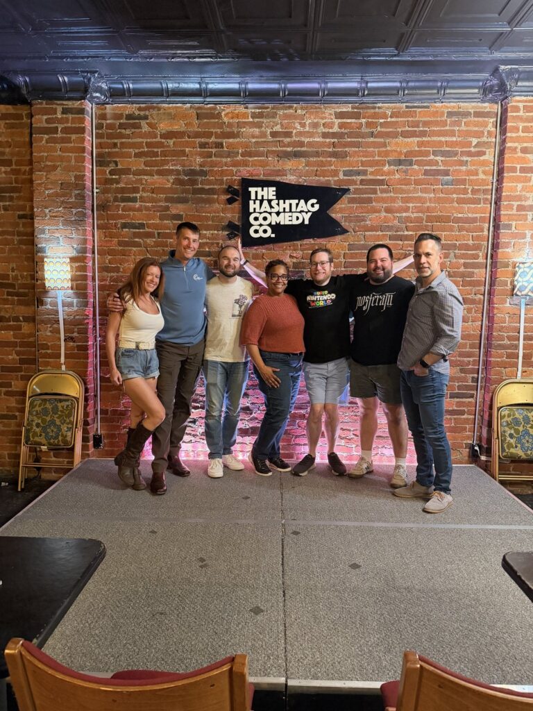 Phil Ratcliff with his improv class on stage, September 2026