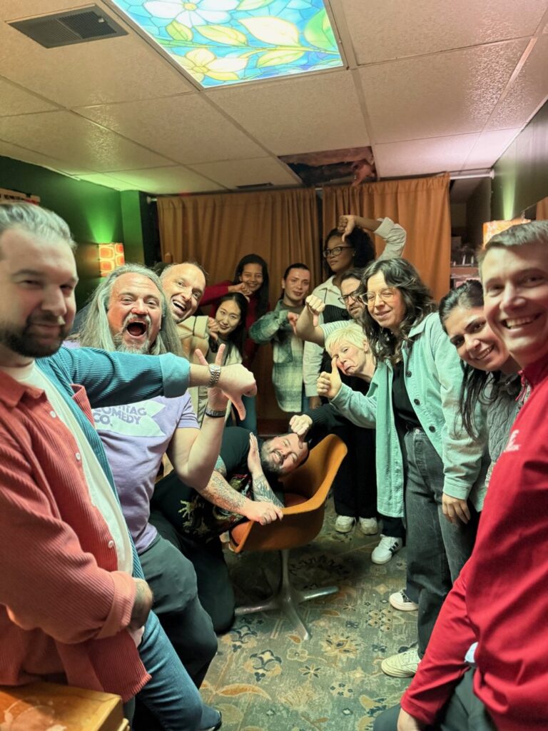 Phil Ratcliff and his improv class celebrating after a show